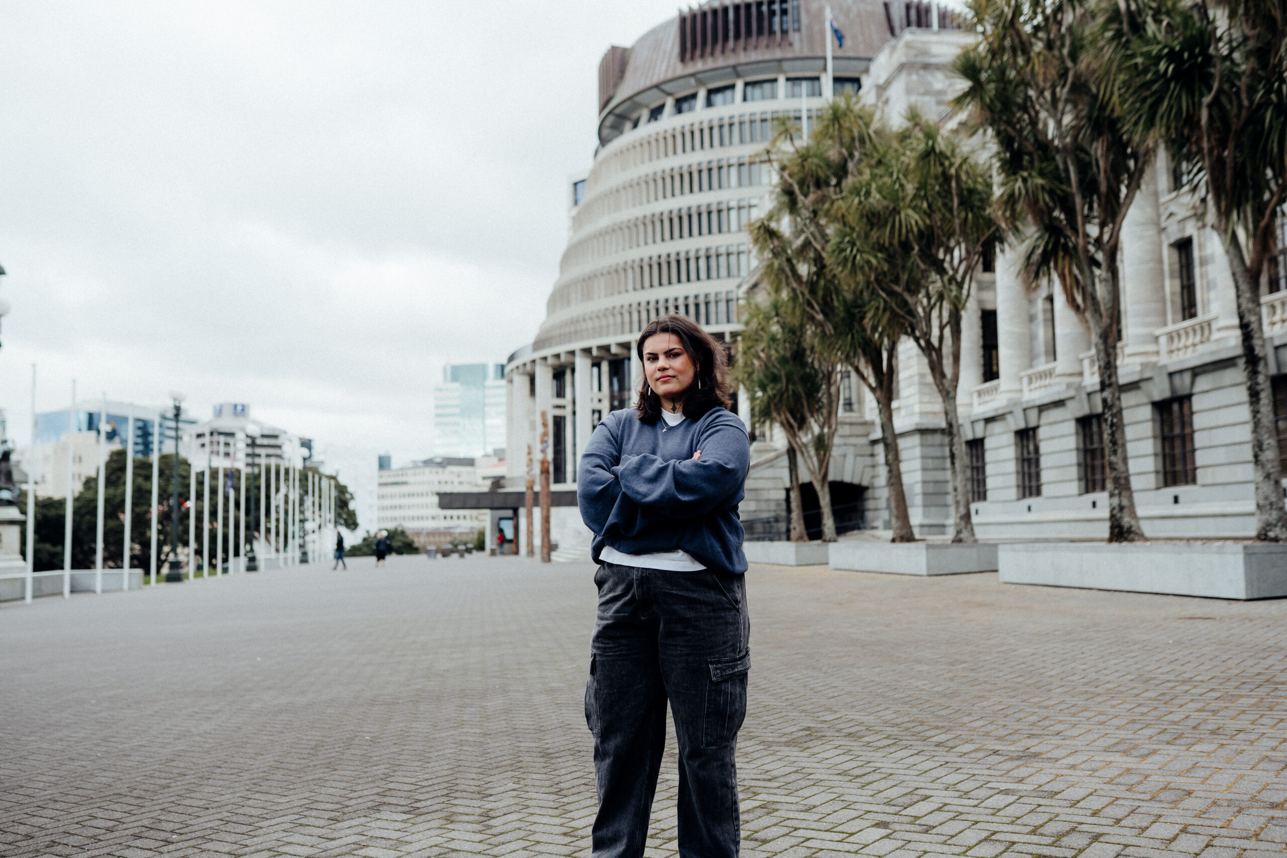 Woman standing confidently in front of Parliament buildings